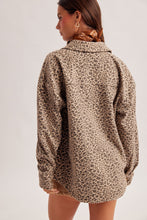 Load image into Gallery viewer, Back view of a model wearing a neutral animal print shacket with long cuffed sleeves and a curved hem.

