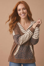 Load image into Gallery viewer, Model wearing a brown mixed media hoodie with striped sleeves and a leopard print kangaroo pocket.
